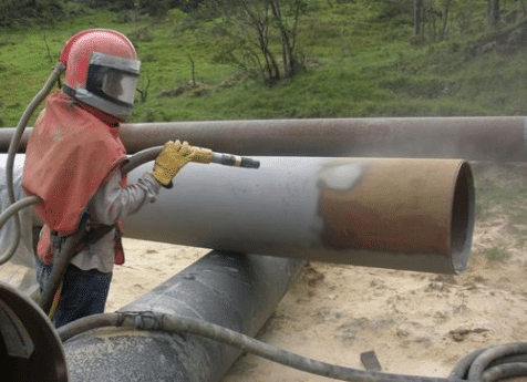 Abrasive blasting of steel pipe before protective coating